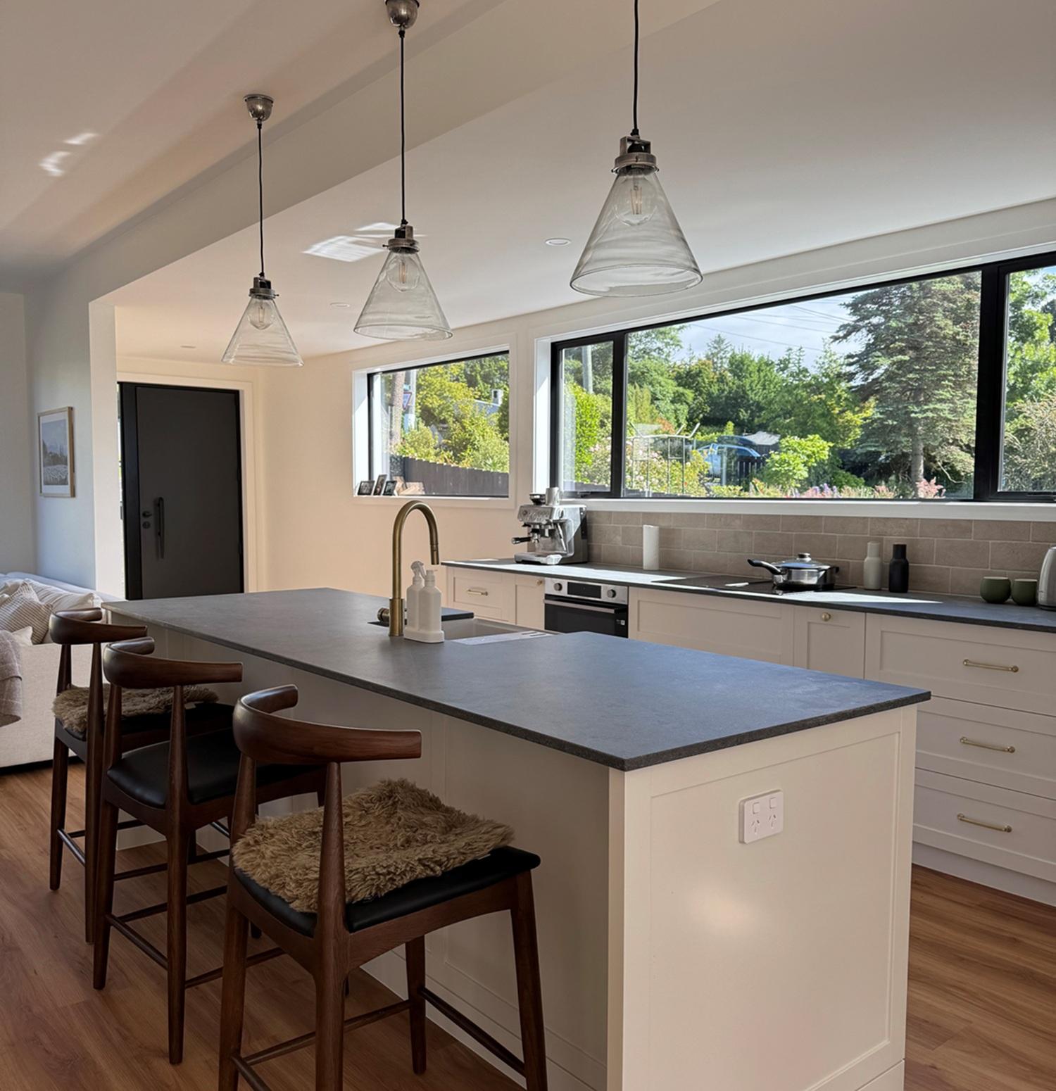 Kitchen with pendant lights and harbour-facing windows in a Gray Brothers build